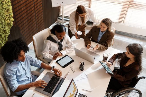 A diverse team discussing CSR initiatives for employees during a team meeting.