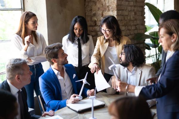A group of professional colleagues gathers to discuss how they can increase the impact of their company's employee grant scheme.