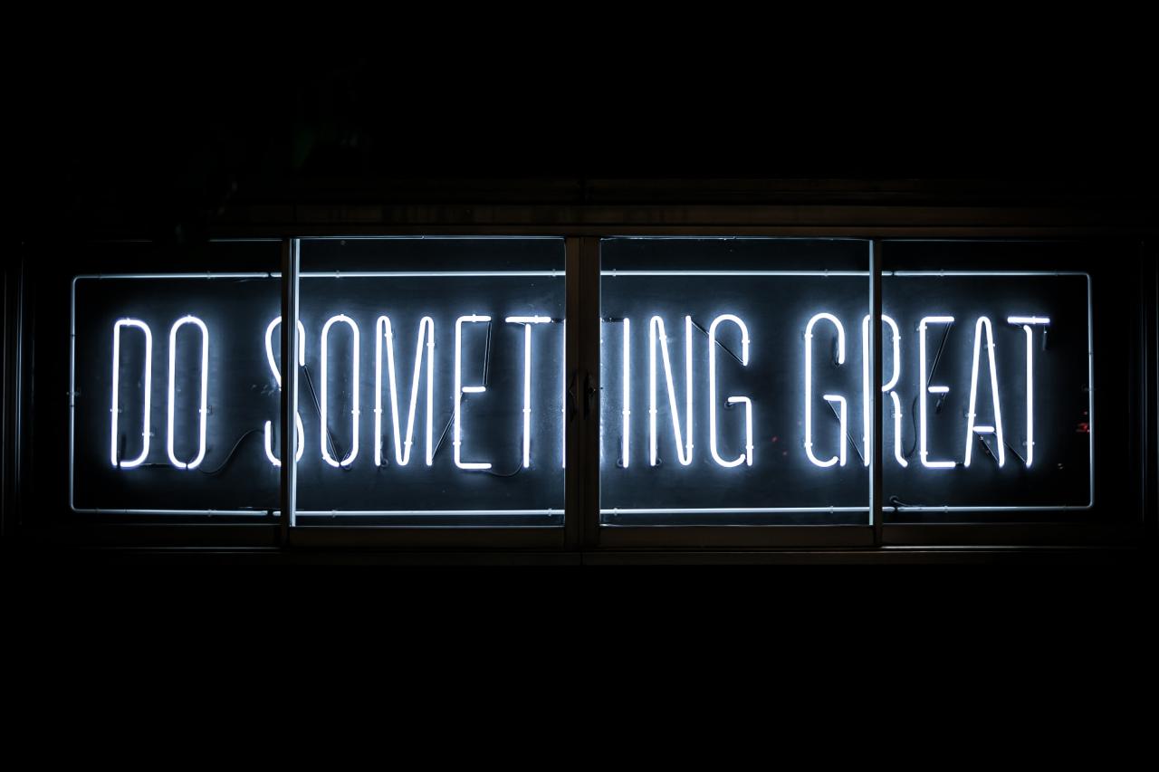 Neon sign reads "do something great"