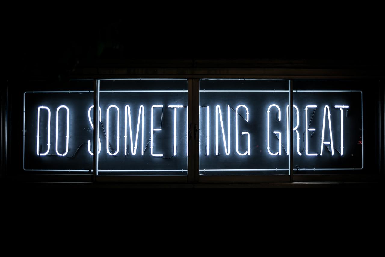 Neon sign reads "do something great"