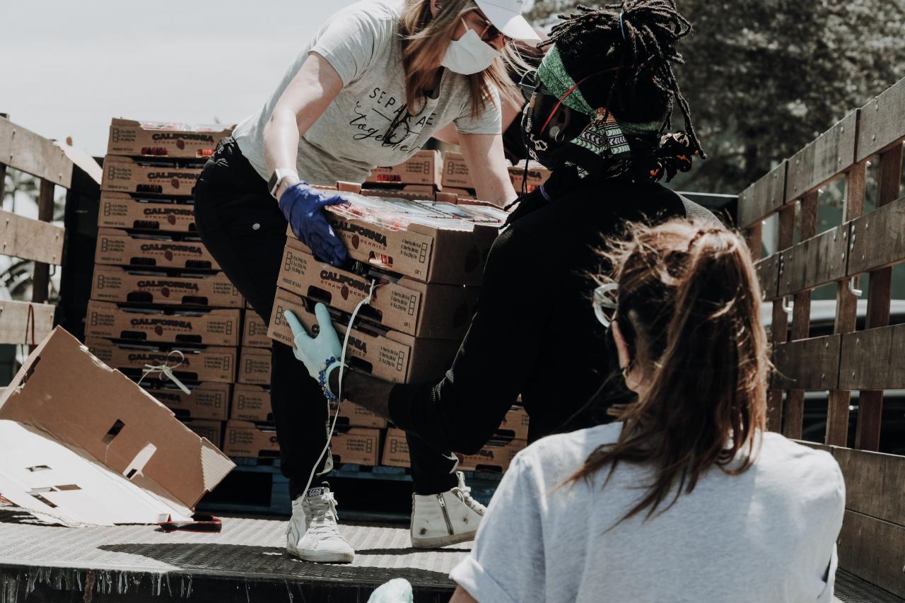 Volunteers helping unload donations from a truck.