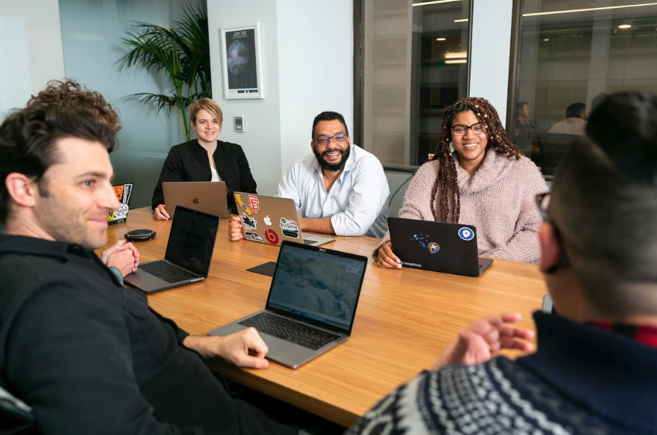 Team meeting around table engaging employees with ESG