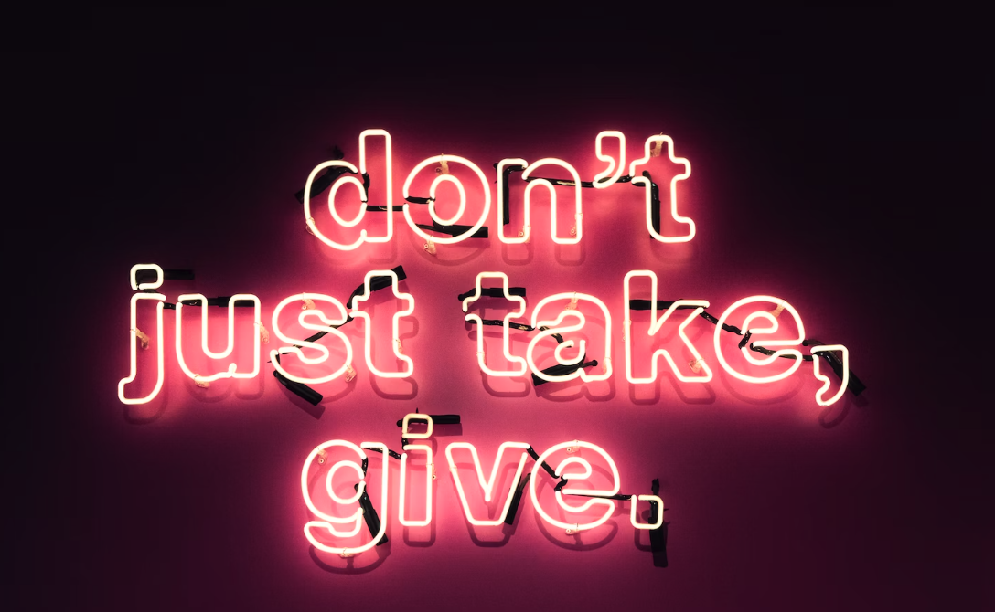 What is employee giving? A red neon sign reads "don't just take, give"