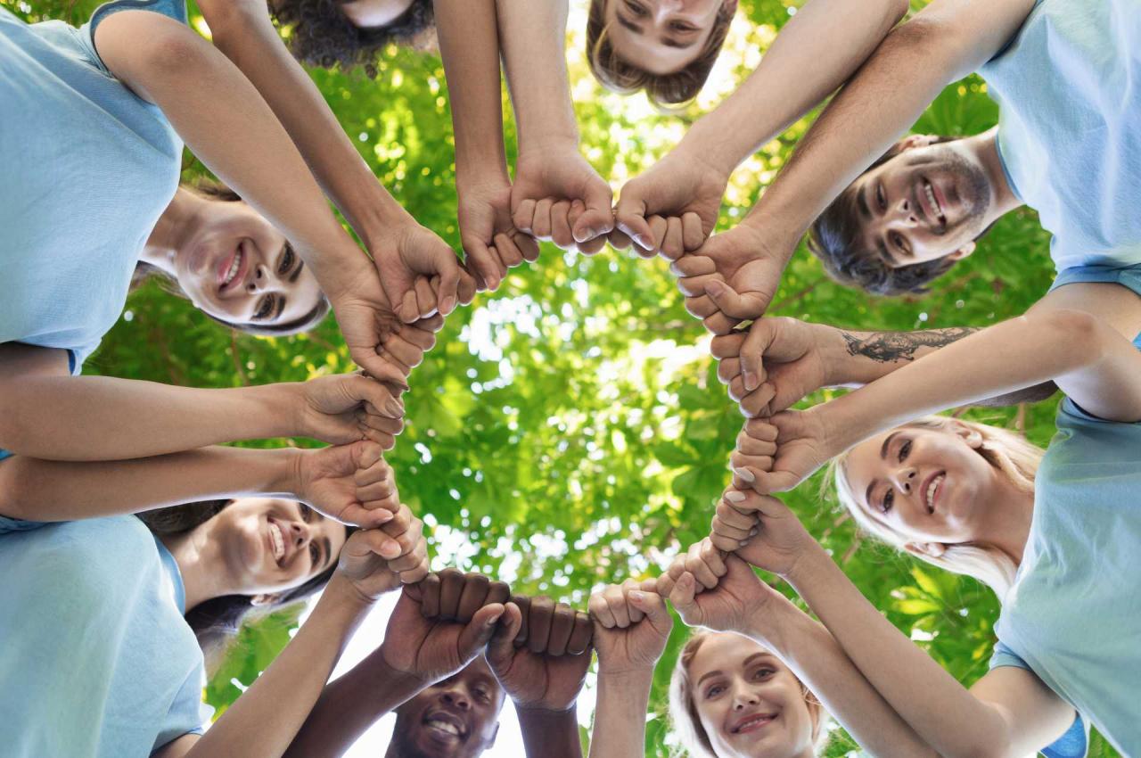 group of people holding hands in unity for csr activities