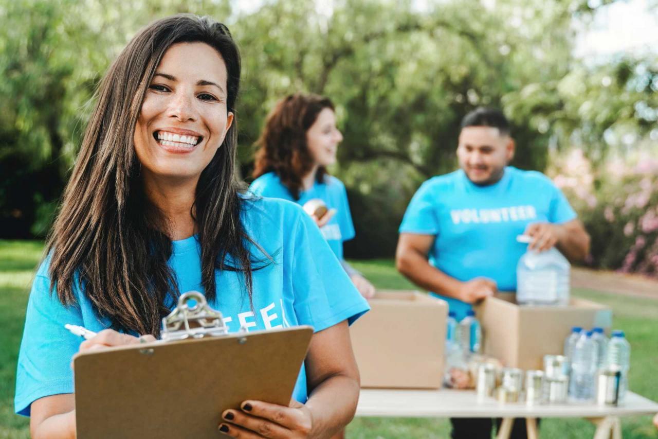 corporate philanthropy is, corporate volunteers collecting goods and food for community service at a park.