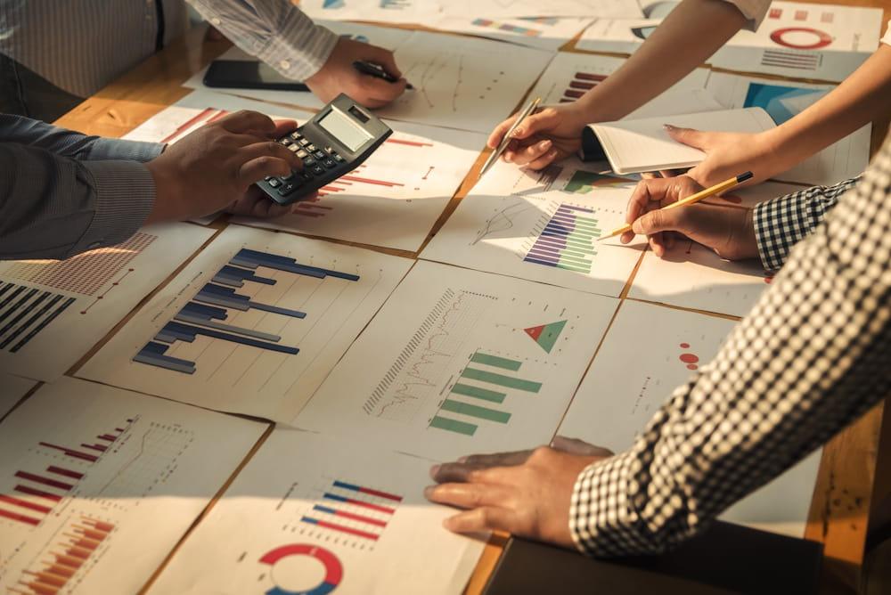 A team analyzing corporate social responsibility metrics and CSR impact measurement data.
