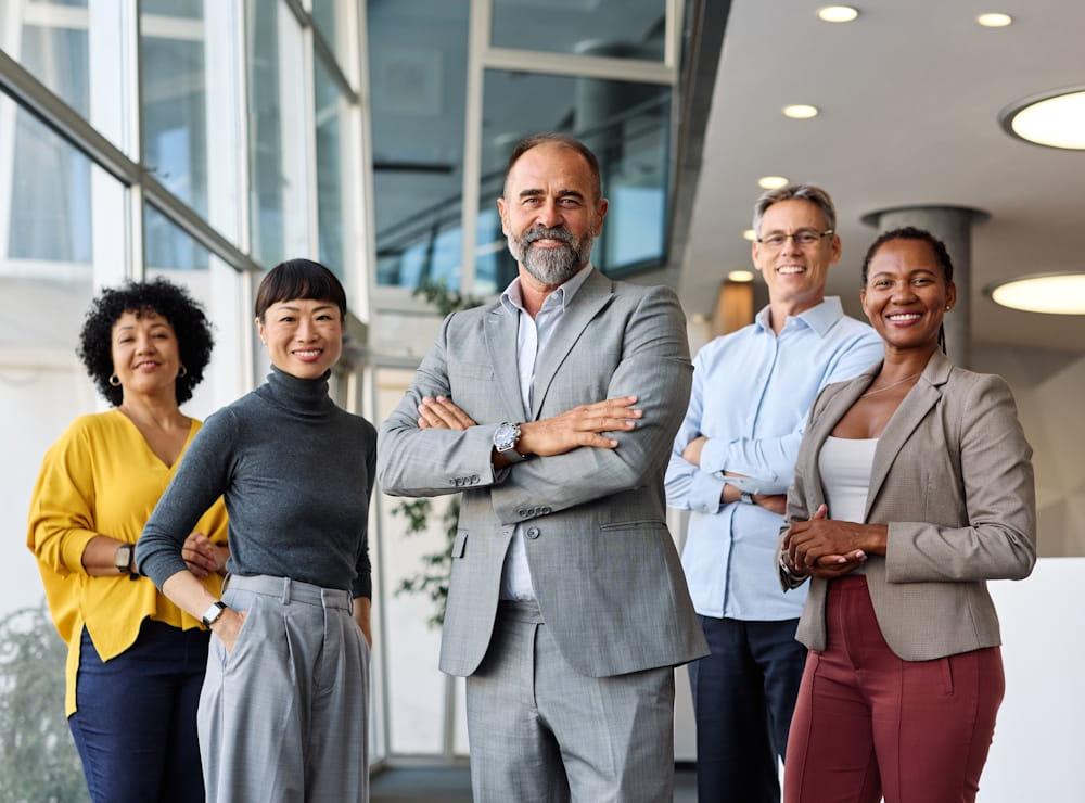 A CFO standing in front of its team, evaluating the impact of donation matching on the broader company operations