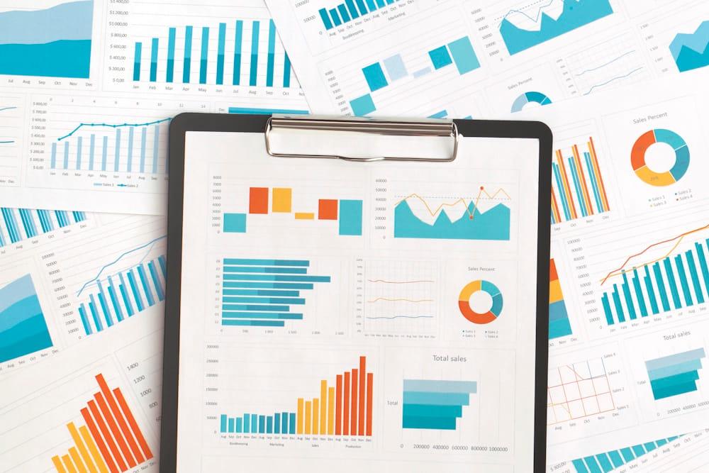 Clipboard with charts to measure CSR impact and ESG impact reporting data.