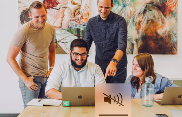 Engaged employees around a laptop