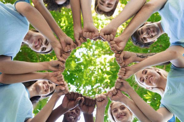 group of people holding hands in unity for csr activities